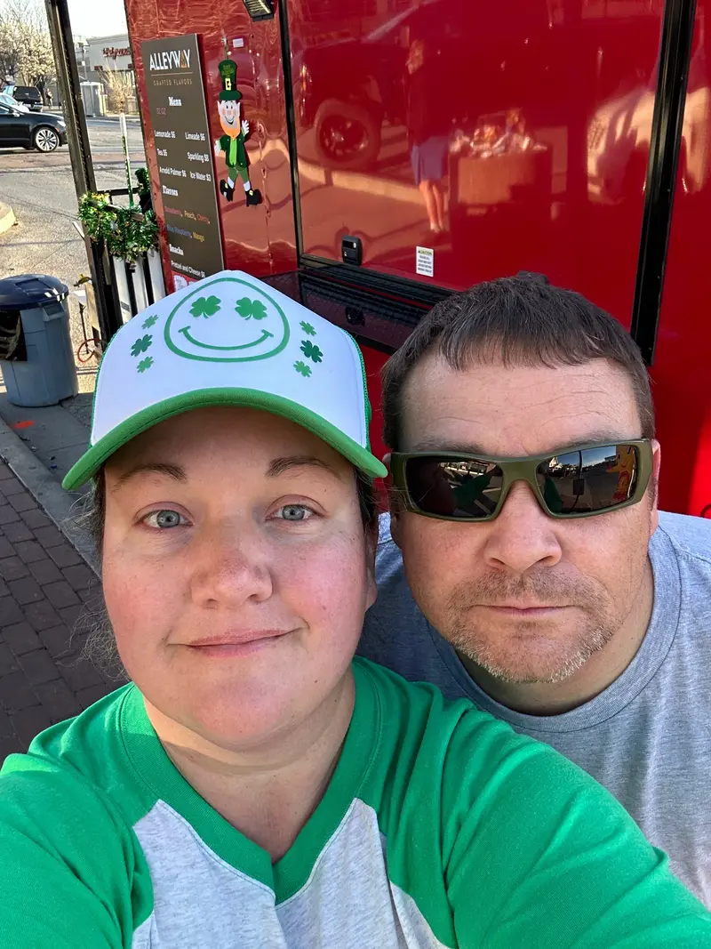 Laura and Donald Helton beside the trailer.